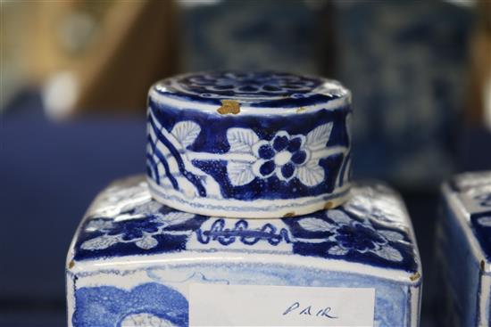 A pair of Dutch delft blue and white lidded tea caddies